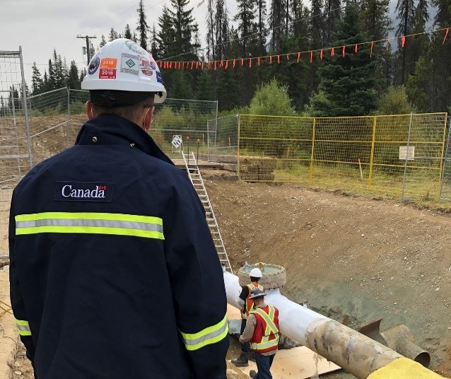 Figure&nbsp;4 &ndash; A CER Inspector observes work on a section of pipe at a Trans Mountain site, near Jasper, Alberta.