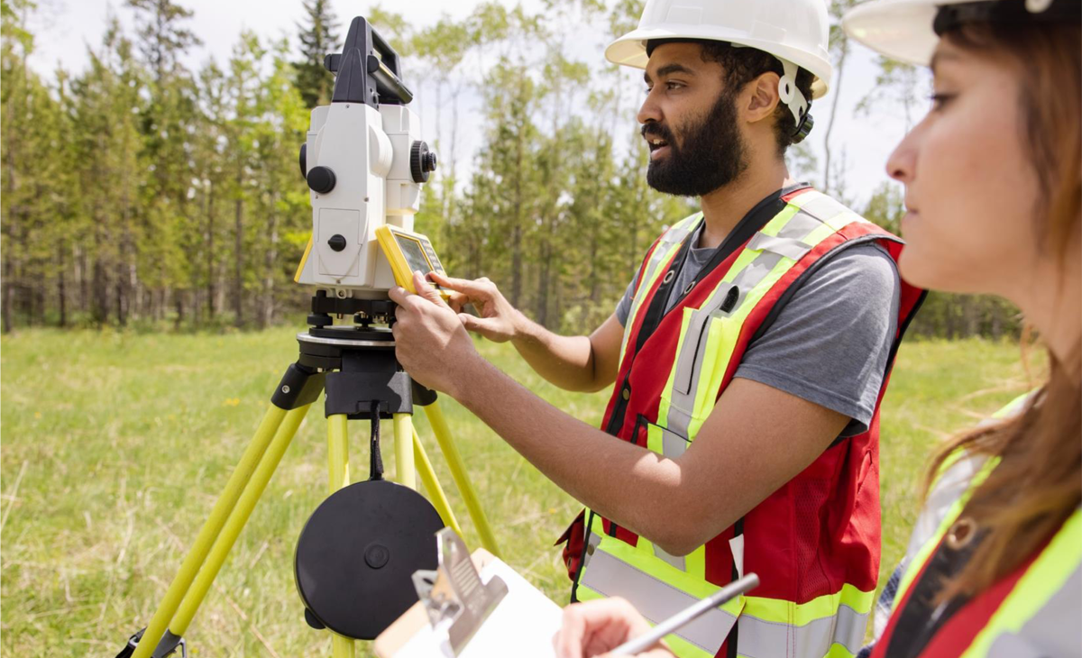 Figure&nbsp;5 &ndash; Surveyors using equipment to measure a field
