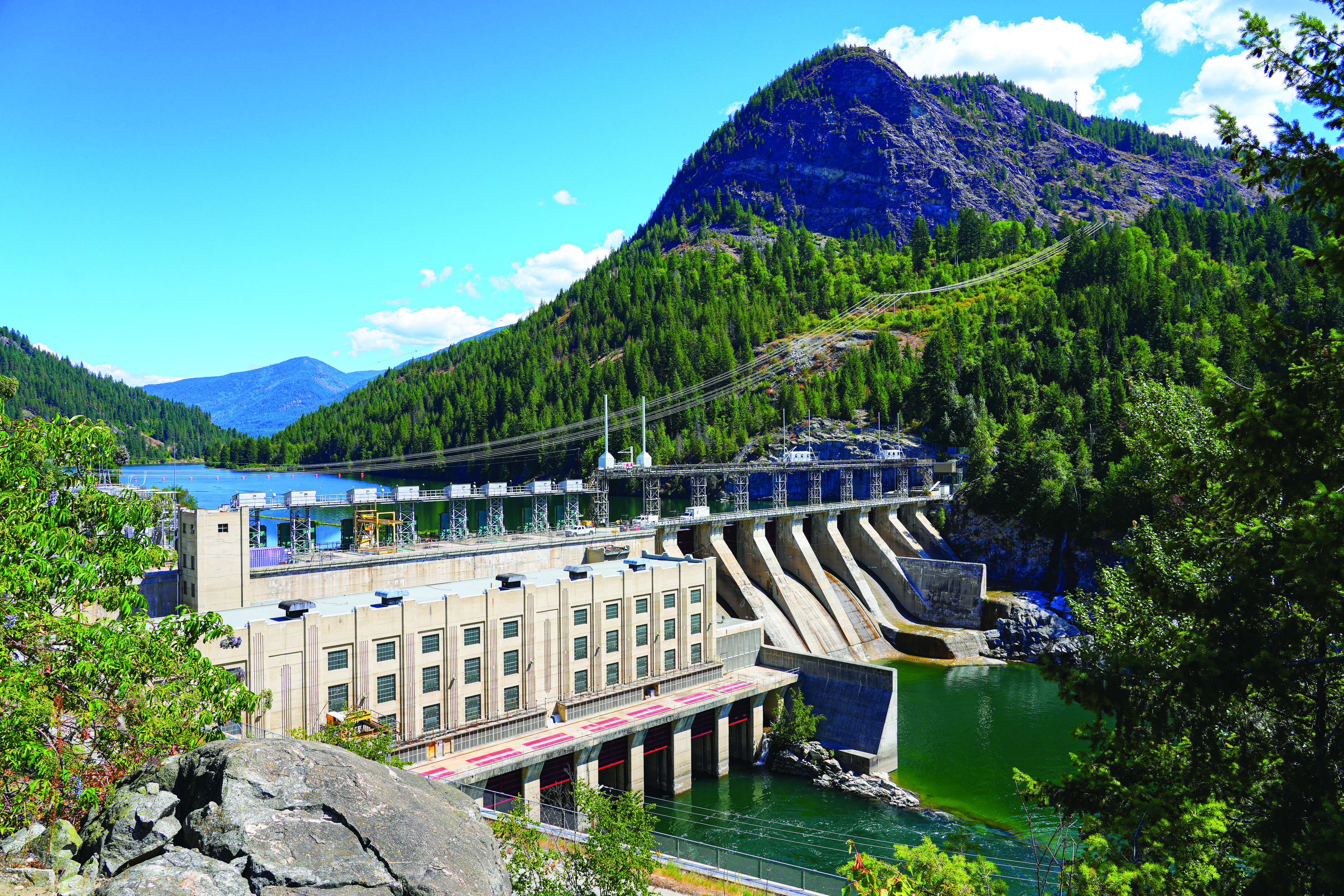 Hydroelectricity dam on the Kootenay river upstream from Castlegar in the west Kootenay region of British Columbia on a bright sunny day.