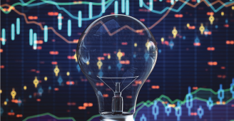 Stock market charts with lightbulb in front.