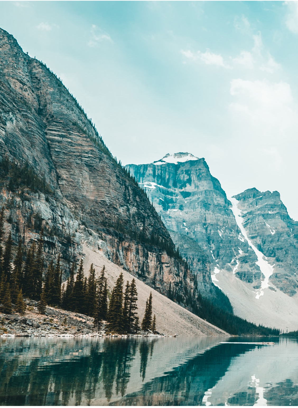 Mountains stand along the edge of a lake