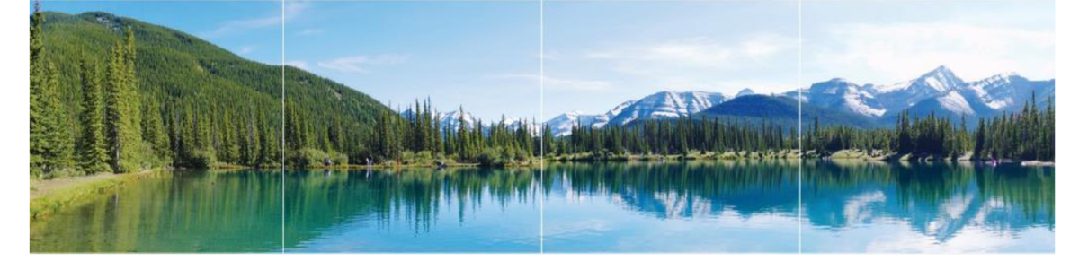 A mountain lake surrounded by green trees in the summer