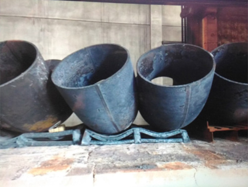 Figure 8 &ndash; Improper furnace loading simulation, areas of low yield strength on the elbows have been linked to where the fittings touch each other and the pallets on which they sit